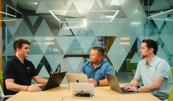 IT leaders discussing Microsoft 365 Copilot strategy around a conference table