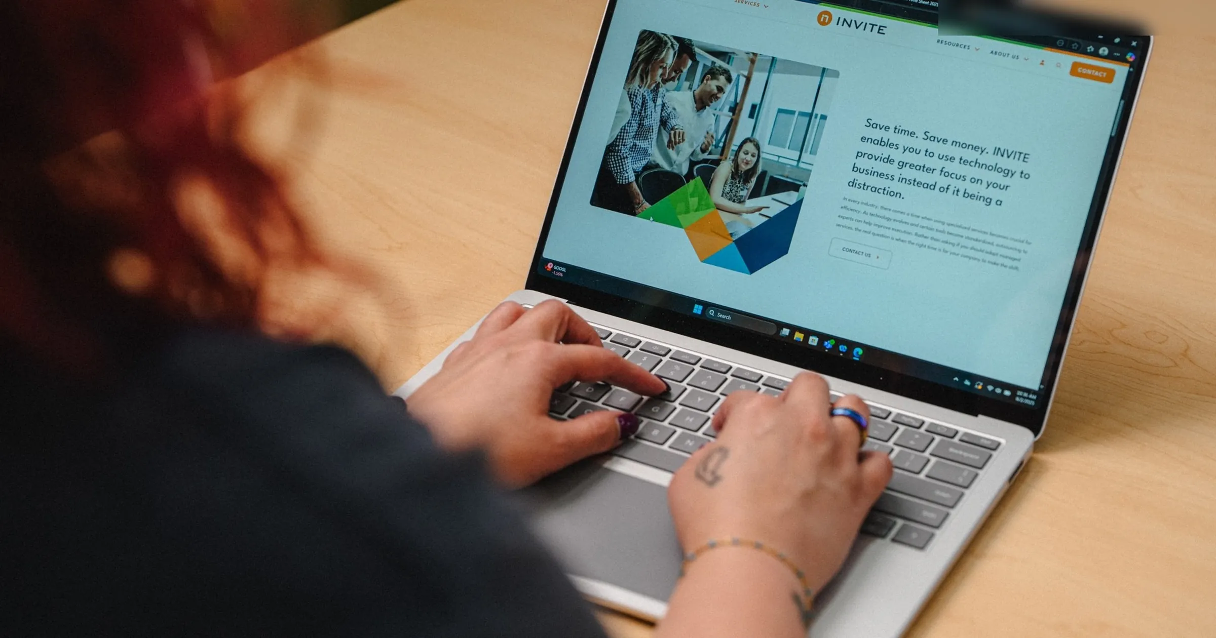 INVITE employee reviewing the INVITE Networks managed services page on a laptop while planning an enterprise AI strategy