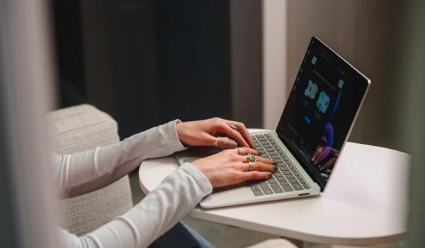 IT professional typing on a laptop in a lounge chair, representing security framework planning with CIS Controls and NIST CSF