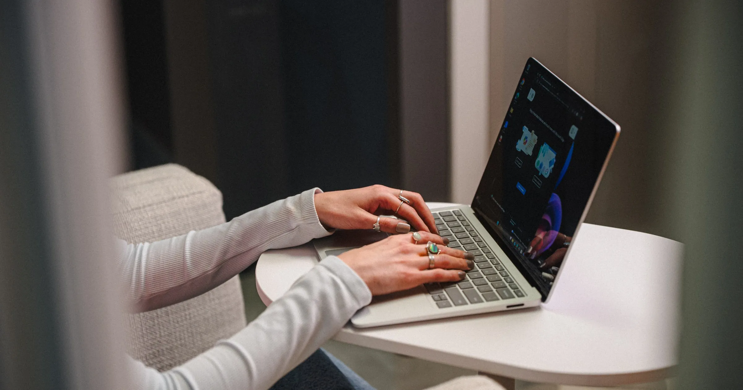 IT professional typing on a laptop in a lounge chair, representing security framework planning with CIS Controls and NIST CSF