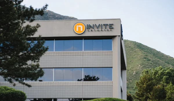 INVITE Networks headquarters building with the INVITE logo against the Wasatch foothills